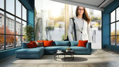 pretty woman in business suit with bag stylish trendy with glasses and professional executive theme Wall mural