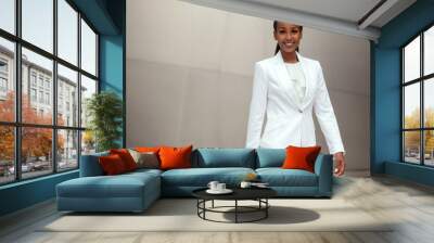 Sharply dressed stylish business woman walking portrait in suit at office financial workplace. african american female Wall mural