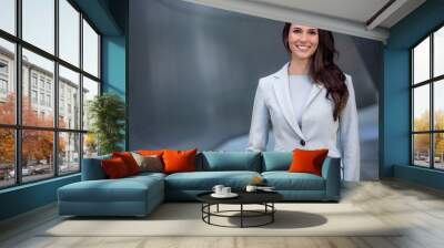 Smiling beautiful commercial model business woman professional entrepreneur in a suit with copy space Wall mural