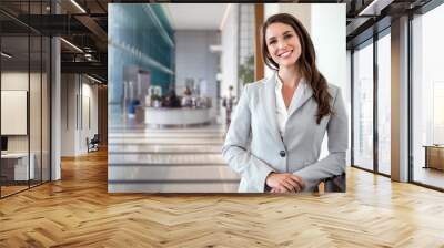 Smiling likable sincere and charming business woman financial executive type portrait inside commercial building Wall mural