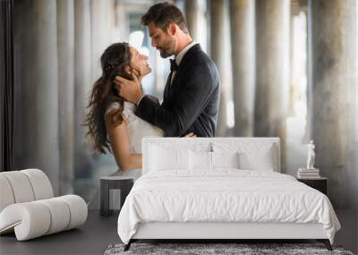 Stunning artistic portrait of bride and groom in love embracing with gorgeous background Wall mural