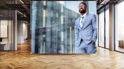 Young accomplished african american CEO business founder entrepreneur, stylish suit and glasses standing confidently at workplace office building Wall mural