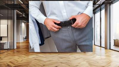 Businessman dressing up for work Wall mural