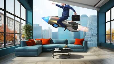 Businessman flying on rocket in business concept Wall mural