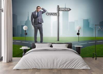 Businessman in difficult choice concept Wall mural