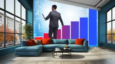 Businessman standing next to bar chart in business concept Wall mural