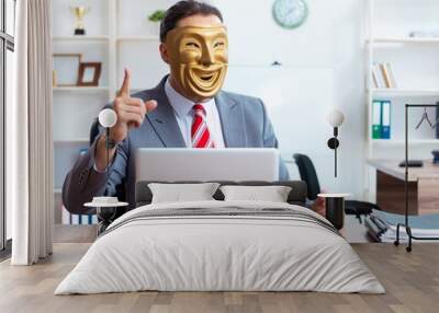 Businessman wearing mask in hypocrisy concept Wall mural