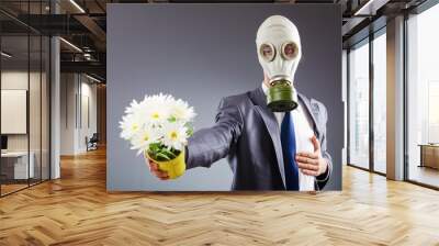 Businessman with gas mask and flowers Wall mural