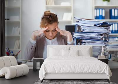 Businesswoman very busy with ongoing paperwork Wall mural