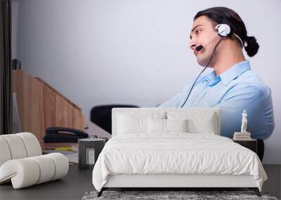 Call center operator working at his desk Wall mural