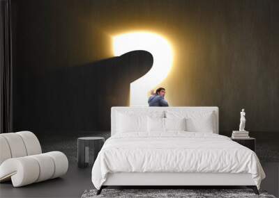 Concept of uncertainty with question and businessman Wall mural