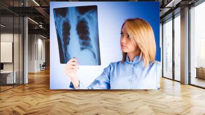 Female doctor carefully x-ray of patient Wall mural