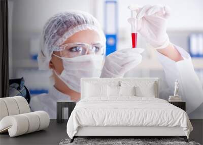 Female scientist researcher conducting an experiment in a labora Wall mural