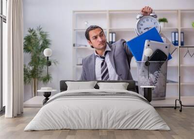 Fired young businessman with recycle bin in time management conc Wall mural