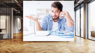 Frustrated young man due to weak internet reception Wall mural