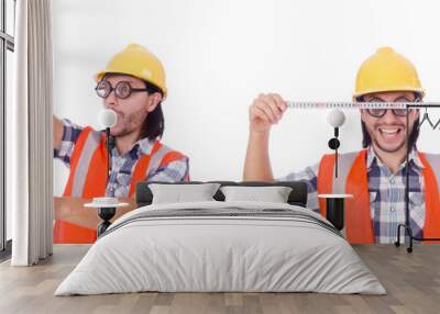 Funny construction worker with tape-line isolated on white Wall mural