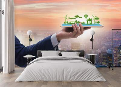 Hand holding tablet with mini ecosystem and clean energy Wall mural