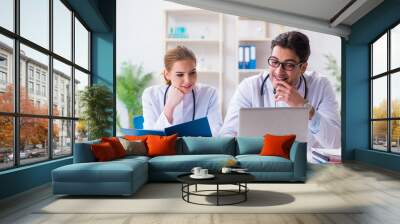 Male and female doctor having discussion in hospital Wall mural