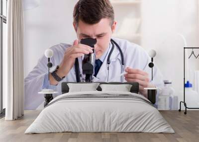 Male doctor looking at lab results in hospital Wall mural