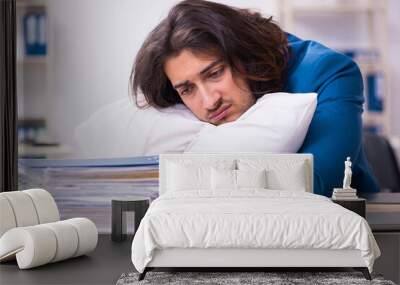 Male employee coming to work straight from bed Wall mural