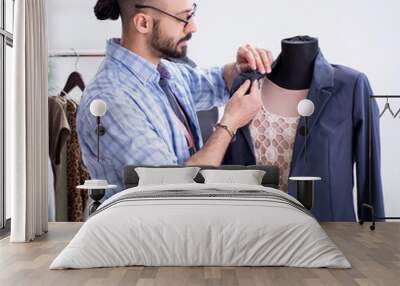 Male tailor working in the workshop on new designs Wall mural