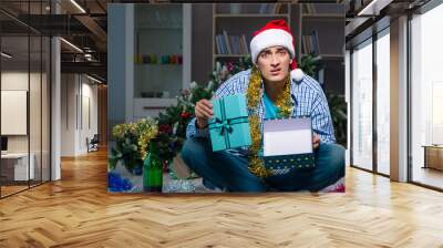 Man celebrating christmas at home alone Wall mural