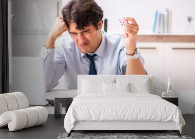 man under stress measuring his blood pressure Wall mural