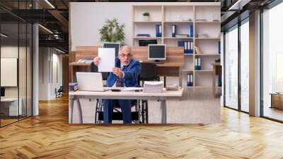 Old businessman employee in wheel-chair working in the office Wall mural