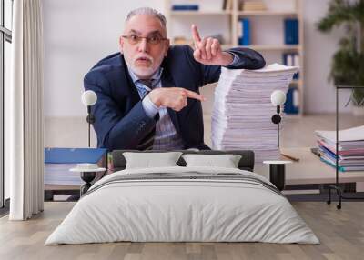 Old businessman employee unhappy with excessive work in the office Wall mural