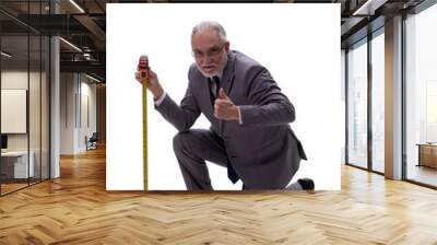 Old businessman holding tape measure isolated on white Wall mural