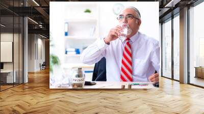 Old male accountant in budget planning concept Wall mural