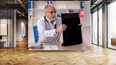 Old male doctor radiologist working in the clinic Wall mural