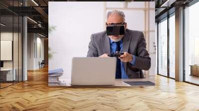 Old male employee enjoying virtual glasses at workplace Wall mural