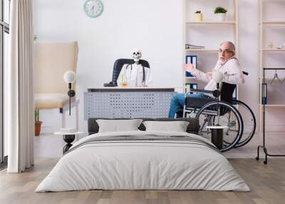 Old man in wheel-chair visiting dead doctor Wall mural