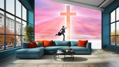 Religious concept with cross and lonely man Wall mural