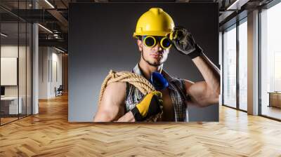 Ripped muscular builder man with tools Wall mural