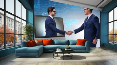 Telepresence concept with two businessman handshaking Wall mural