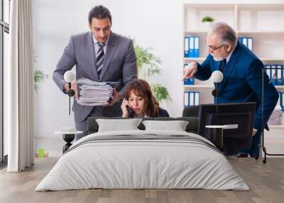 Two male and one female employees working in the office Wall mural