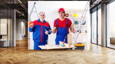 Two professional contractors laying flooring at home   Wall mural