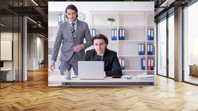 Two young employees working in the office Wall mural