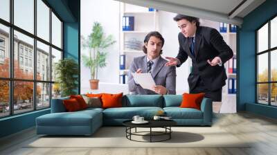 Two young employees working in the office Wall mural