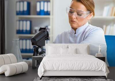 Woman chemist working in hospital clinic lab Wall mural