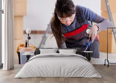 Woman preparing for wallpaper work Wall mural