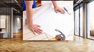 Worker working on wallpaper during refurbishment Wall mural