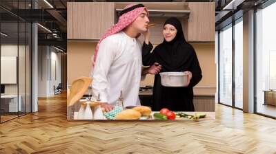 Young arab family in the kitchen Wall mural