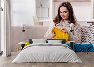 Young beautiful woman knitting at home  Wall mural