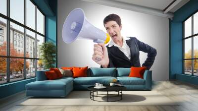 Young business lady screaming to loudspeaker Wall mural