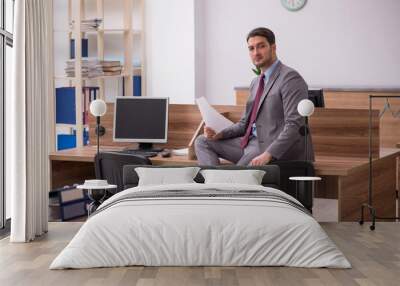 Young businessman employee working in the office Wall mural