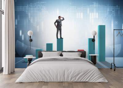 Young businessman in business concept with bar charts Wall mural