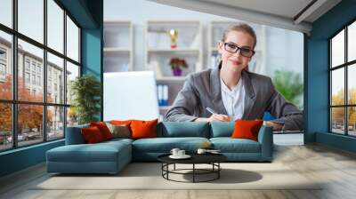 Young businesswoman accountant working in the office Wall mural